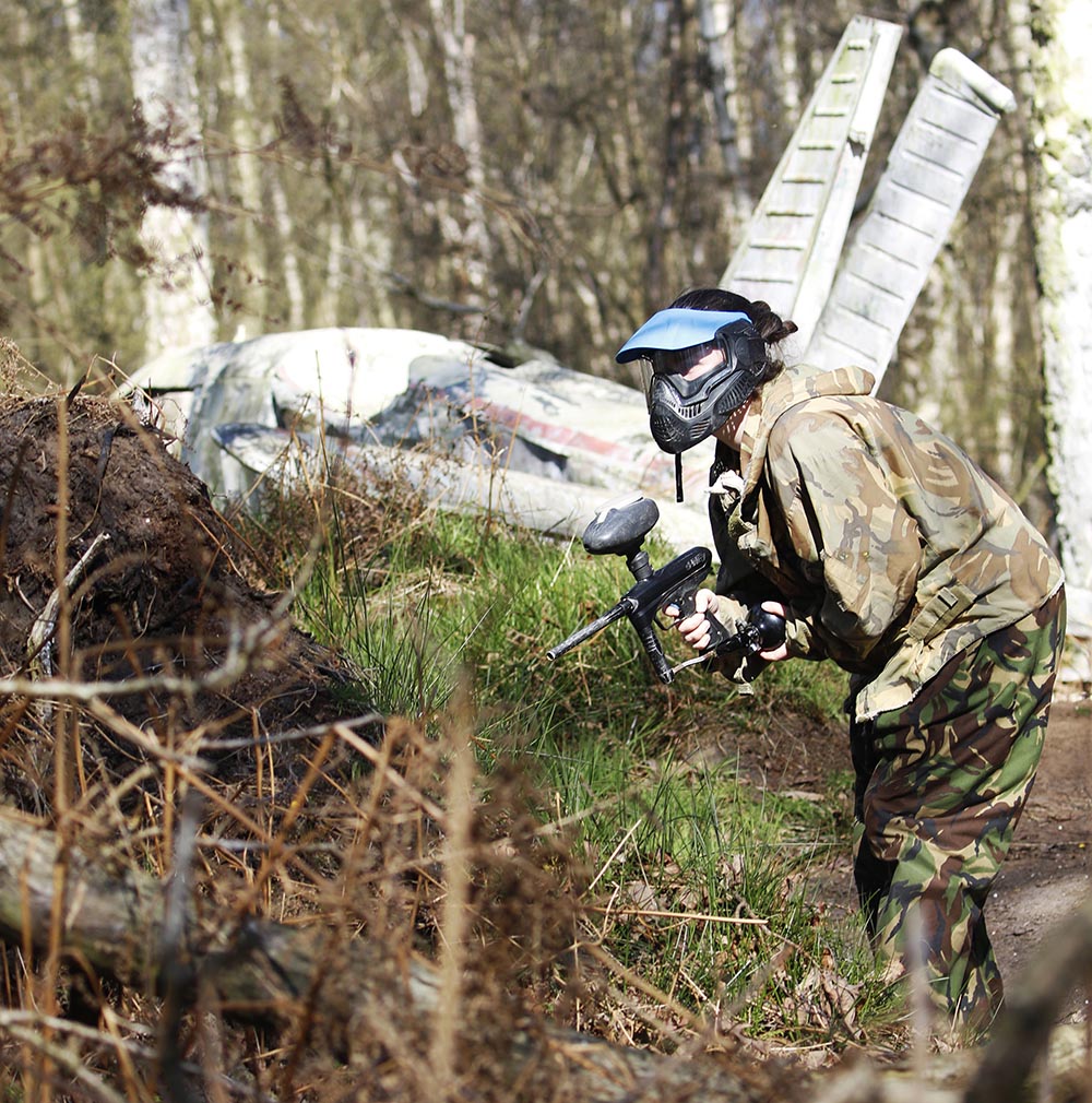 A girl playing paintball in front of our real plane on the airfield map at the Yorkshire Outdoor Activity Park