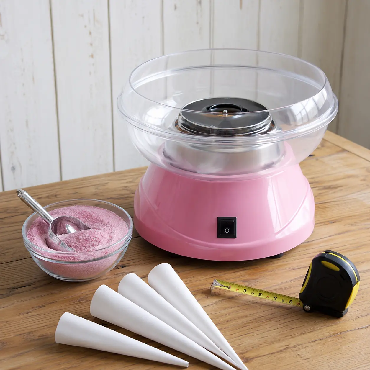 Candy floss machine with sugar cones scoop and tape measure for planning