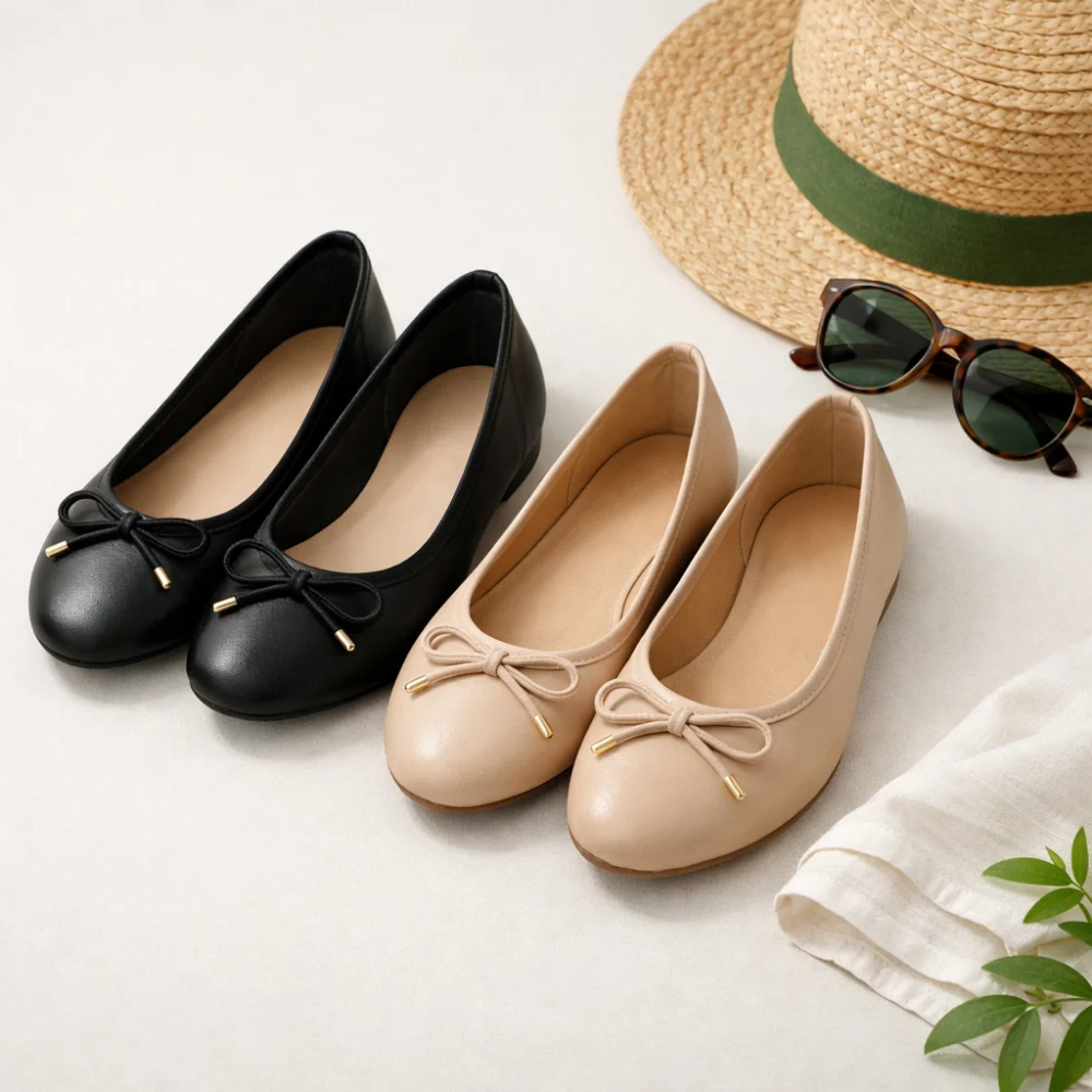 Women’s flat ballet shoes on a plain background